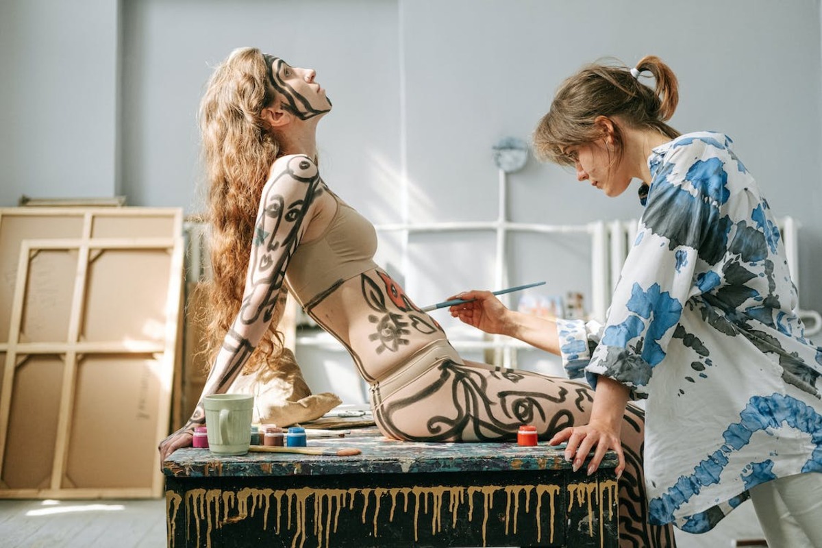 An artist painting a woman's body